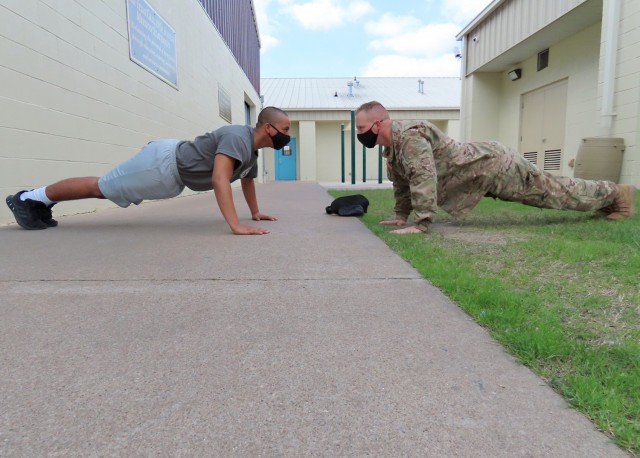 Sgt. Jason Pope conducts push-ups with a candidate during the acclimation phase at the Texas ChalleNGe Academy in Eagle Lake, Texas. The Texas National Guard Joint Counterdrug Task Force has supported the Texas ChalleNGe Academy for more than 20...