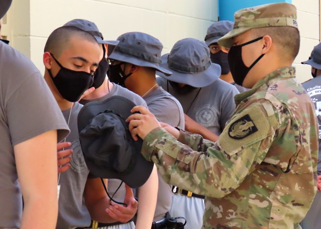 Staff Sgt. Albert Perez helps a candidate with his uniform during the acclimation phase at the Texas ChalleNGe Academy in Eagle Lake, Texas. The Texas National Guard Joint Counterdrug Task Force has supported the Texas ChalleNGe Academy for more...