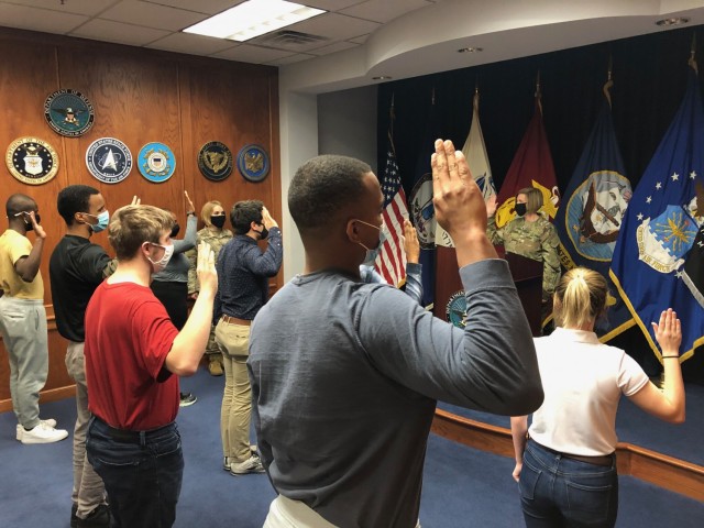 Brig. Gen. Michelle M. T. Letcher, Chief of Ordnance and Commandant of the U.S. Army Ordnance School administers the oath of enlistment to eight enlistees before they ship to Fort Jackson, South Carolina.