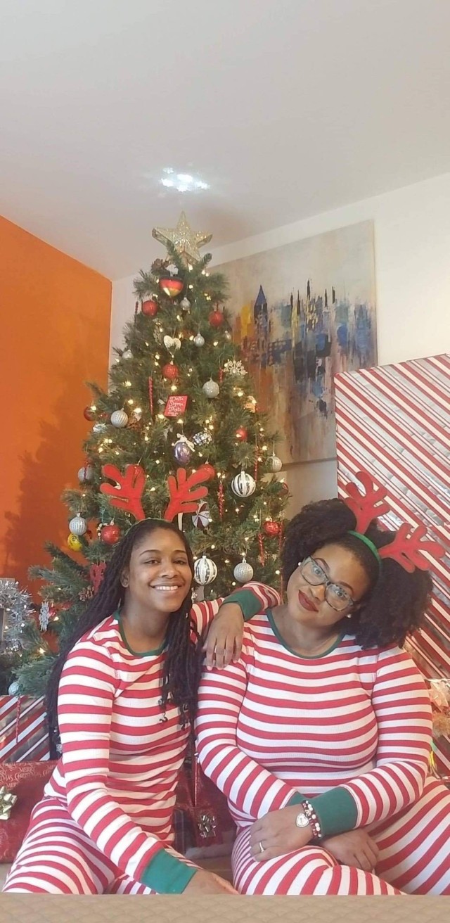 WIESBADEN, Germany – (right to left) Dr. Sturhonda James, Department of Defense cyber security specialist, and her fiancé, Shakima Bates, pose in matching pajamas for their Christmas greetings Dec. 2020.