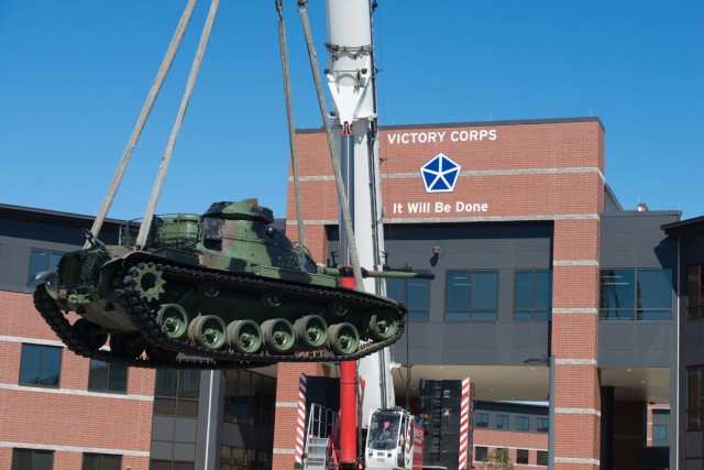 A tank is lowered to its new home in front of the V Corps headquarters at Fort Knox, Ky., Oct. 14, 2020. V Corps was reactivated as command and control support to the Army mission in Europe. After being reactivated following a seven-year pause, V Corps will be tested in several exercises as it seeks to be combat ready by this fall.