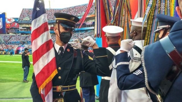 U.S. Army Sgt. Ryan Weber, bearing the National Colors, walks the line wishing his colors team luck just prior to taking the field at Super Bowl LV in Tampa, Florida, Feb. 7, 2021. The U.S. Armed Forces Color Guard is comprised of service members...