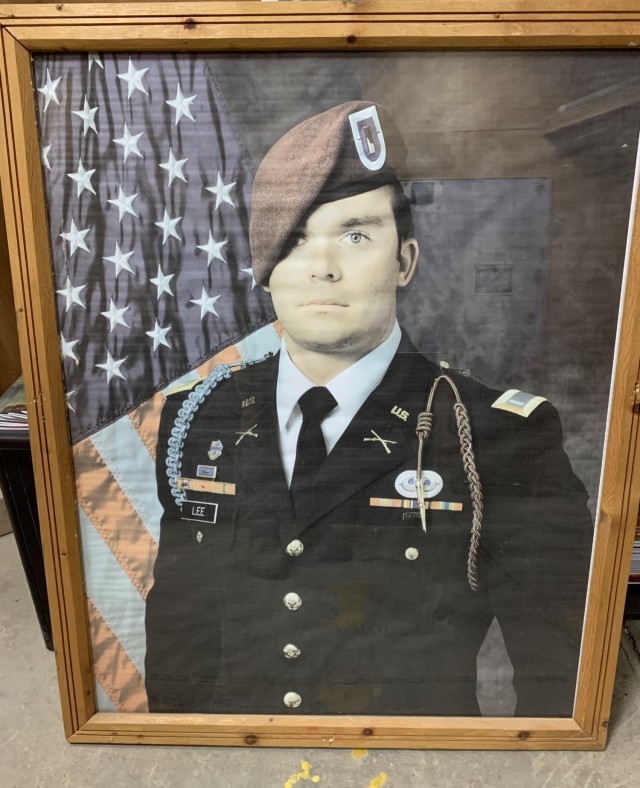 A portrait of U.S. Army 1st Lt. Weston Lee previously hung in the fieldhouse at Camp Taji, Iraq in honor of his sacrifice when he was killed in action in 2017. As the base undergoes transfer to the Iraqi forces, Lee’s portrait was among the memorials that were secured or sanitized before U.S. forces leave the base. (U.S. Army photo by Chaplain (Capt.) Joel Reynolds, 168th Military Police Battalion, Tennessee Army National Guard, Combined Joint Task Force – Operation Inherent Resolve)