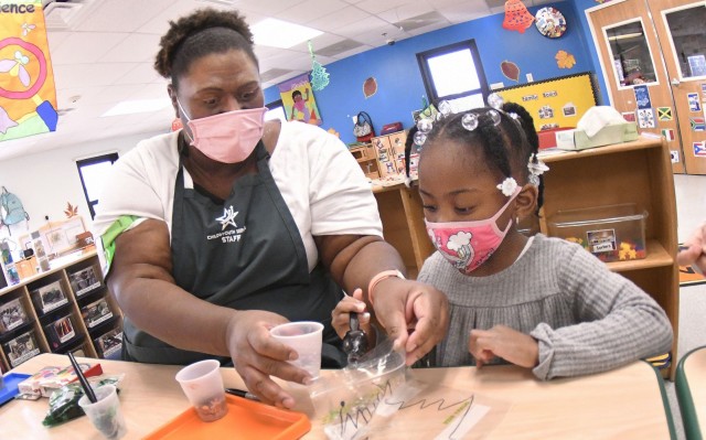 Strong Beginnings Program Assistant Judy Jones works with Madison Easter during a holiday craft-making activity in December at Fort Lee’s Battle Drive Child Development Center. It was recently announced that the Child and Youth Services program...