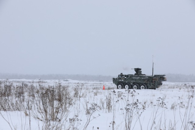 U.S. Army Stryker from Bull Troop, 1st Squadron, 2d Cavalry Regiment, enhanced Forward Presence Battle Group Poland, waits on a range during crew level maneuver platform gunnery qualification tables February 09, 2021, at Bemowo Piskie Training...