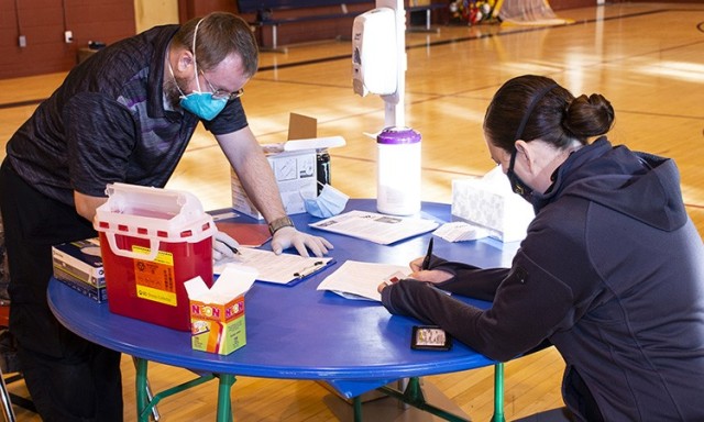 Sage Farmer, Occupational Health Technician, explains an aspect of the Moderna COVID-19 vaccine to Dispatch Supervisor Courtney Montoya. This was the first of two inoculations for emergency personnel at Dugway Proving Ground, the second won’t be...