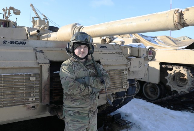 Cpl. Keaton Williamson, a tanker assigned to Bravo “Eagar Arms” Company, 2nd Battalion, 8th Cavalry Regiment, poses with the Abrams tank he operates while deployed to the Pabrade Training Area, Lithuania. Williamson’s Family have long served...