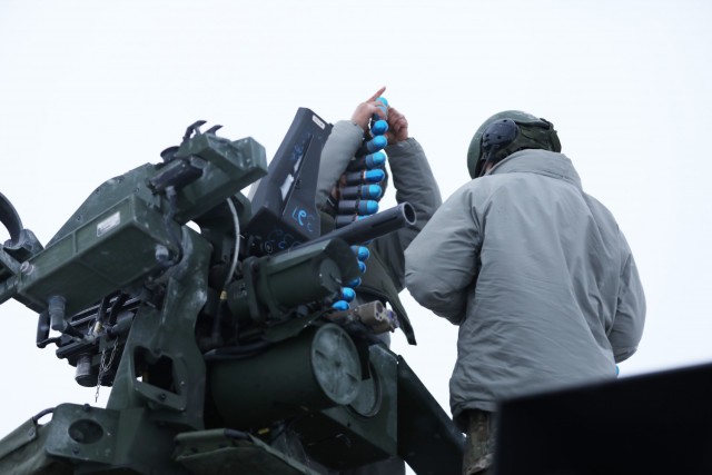 Newly arrived U.S. Army Soldiers from Bull Troop, 1st Squadron, 2d Cavalry Regiment, enhanced Forward Presence Battle Group Poland, load rounds into stryker before crew level maneuver platform gunnery qualification tables February 09, 2021, on a...