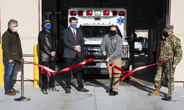 A red ribbon to welcome the new ambulance garage in English Village was cut Feb. 3, 2021. The heated and air conditioned two-unit garage eliminates snow or ice removal from vehicles, cutting five minutes off response time.
Left to right: MICC Contracting Officer Paul Frailey, Civil Engineer Kent Hawkins, Garrison Manager Aaron Goodman, EMS Coordinator John Mittelman (cutting ribbon), and DPG Commander Col. Scott Gould.
Photo by Al Vogel, Dugway Public Affairs

