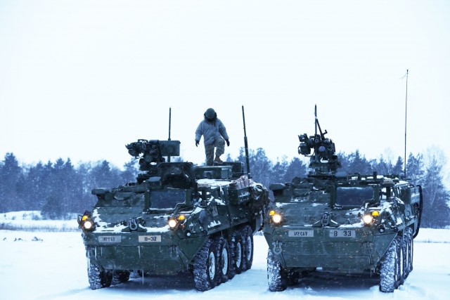 Newly arrived U.S. Army Soldiers from Bull Troop, 1st Squadron, 2d Cavalry Regiment, enhanced Forward Presence Battle Group Poland, ready their vehicles before crew level maneuver platform gunnery qualification tables February 09, 2021, on a range...