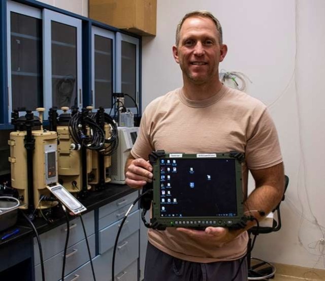 Jon Hogan, physical scientist and test officer, holds a ruggedized tablet that warfighters will use to monitor the Joint Biological Tactical Detector System (JBTDS). The detector system is undergoing rigorous testing at Dugway Proving Ground.