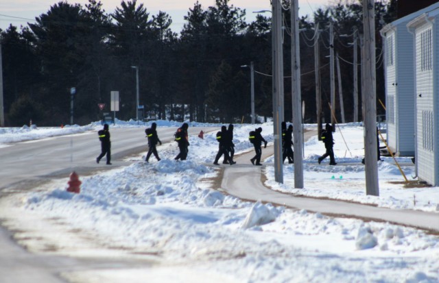 U.S. Navy recruits walk on the cantonment area Jan. 28, 2021, at Fort McCoy, Wis. The Navy’s Recruit Training Command (RTC) of Great Lakes, Ill., worked with the Army in 2020 at Fort McCoy so the post could serve as a restriction-of-movement (ROM) site for Navy recruits prior to entering basic training. Additional personnel support from the Navy’s Great Lakes, Ill., Millington, Tenn., and Washington, D.C., sites deployed to McCoy to assist RTC in conducting the initial 14-day ROM to help reduce the risk of bringing the coronavirus to RTC should any individual be infected. More than 40,000 recruits train annually at the Navy’s only boot camp. This is also the first time Fort McCoy has supported the Navy in this capacity. Fort McCoy’s motto is to be the “Total Force Training Center.” (U.S. Army Photo by Scott T. Sturkol, Public Affairs Office, Fort McCoy, Wis.)