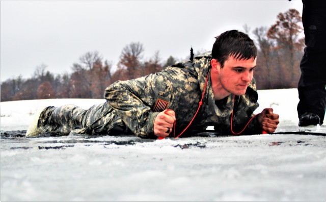 A Fort McCoy Cold-Weather Operations Course (CWOC) Class 21-02 student participates in cold-water immersion training Jan. 15, 2021, at Big Sandy Lake on South Post at Fort McCoy, Wis. CWOC students are trained on a variety of cold-weather subjects, including snowshoe training and skiing as well as how to use ahkio sleds and other gear. Training also focuses on terrain and weather analysis, risk management, cold-weather clothing, developing winter fighting positions in the field, camouflage and concealment, and numerous other areas that are important to know in order to survive and operate in a cold-weather environment. The training is coordinated through the Directorate of Plans, Training, Mobilization and Security at Fort McCoy. (U.S. Army Photo by Scott T. Sturkol, Public Affairs Office, Fort McCoy, Wis.)