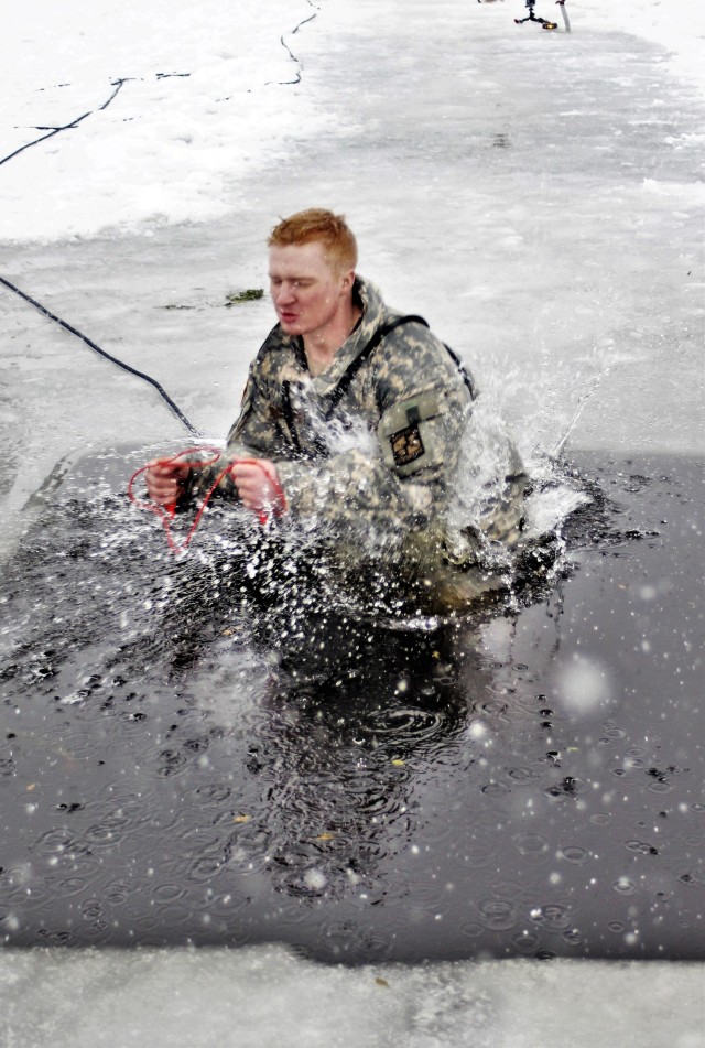 A Fort McCoy Cold-Weather Operations Course (CWOC) Class 21-02 student participates in cold-water immersion training Jan. 15, 2021, at Big Sandy Lake on South Post at Fort McCoy, Wis. CWOC students are trained on a variety of cold-weather subjects, including snowshoe training and skiing as well as how to use ahkio sleds and other gear. Training also focuses on terrain and weather analysis, risk management, cold-weather clothing, developing winter fighting positions in the field, camouflage and concealment, and numerous other areas that are important to know in order to survive and operate in a cold-weather environment. The training is coordinated through the Directorate of Plans, Training, Mobilization and Security at Fort McCoy. (U.S. Army Photo by Scott T. Sturkol, Public Affairs Office, Fort McCoy, Wis.)