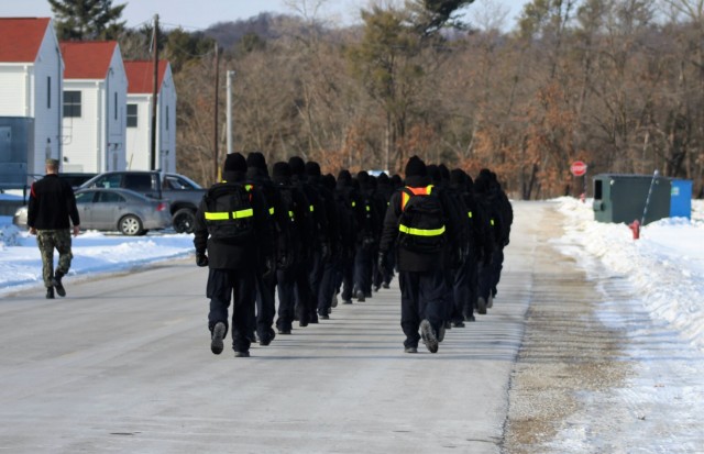 U.S. Navy recruits walk on the cantonment area Jan. 28, 2021, at Fort McCoy, Wis. The Navy’s Recruit Training Command (RTC) of Great Lakes, Ill., worked with the Army in 2020 at Fort McCoy so the post could serve as a restriction-of-movement (ROM) site for Navy recruits prior to entering basic training. Additional personnel support from the Navy’s Great Lakes, Ill., Millington, Tenn., and Washington, D.C., sites deployed to McCoy to assist RTC in conducting the initial 14-day ROM to help reduce the risk of bringing the coronavirus to RTC should any individual be infected. More than 40,000 recruits train annually at the Navy’s only boot camp. This is also the first time Fort McCoy has supported the Navy in this capacity. Fort McCoy’s motto is to be the “Total Force Training Center.” (U.S. Army Photo by Scott T. Sturkol, Public Affairs Office, Fort McCoy, Wis.)