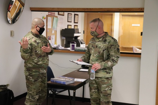 Command Sgt. Maj. Paul Mantha, garrison command sergeant major, receives paperwork to complete in order to receive a COVID-19 vaccination Jan. 26, 2021, at the Fort McCoy Health Clinic during the first round of COVID-19 vaccinations at Fort McCoy,...