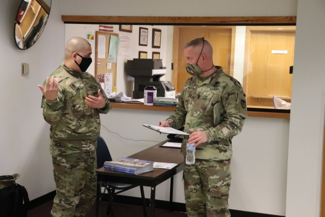 Command Sgt. Maj. Paul Mantha, garrison command sergeant major, receives paperwork to complete in order to receive a COVID-19 vaccination Jan. 26, 2021, at the Fort McCoy Health Clinic during the first round of COVID-19 vaccinations at Fort McCoy, Wis. Mantha was among several people to receive the vaccine at the post. The effort was the beginning of many rounds of vaccinations at the installation. The COVID-19 vaccine is now available due in large part to the Department of Defense effort for Operation Warp Speed to get vaccines to the American people. (U.S. Army Photo by Scott T. Sturkol, Public Affairs Office, Fort McCoy, Wis.)