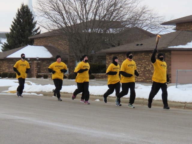 Members of the Fort McCoy, Wis., Army Ten-Miler team carry an event torch Jan. 29, 2021, as part of the opening ceremony of the Sparta Quest Winter Fest in Sparta, Wis. On Jan. 29, members of the team, along with Command Sgt. Maj. Paul Mantha,...