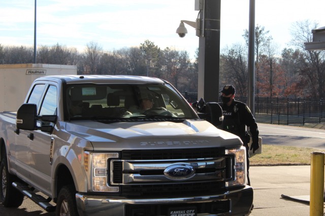 A police officer with the Directorate of Emergency Services Police Department scans an identification card while practicing COVID-19 safety protocols Dec. 3, 2020, at Fort McCoy, Wis. Throughout the installation's pandemic response, which started...