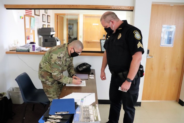 Police Sgt. Kevin Eckelberg with the Directorate of Emergency Services Police Department signs in at the Occupational Health Clinic to receive a COVID-19 vaccination Jan. 28, 2021, at Fort McCoy, Wis. Fort McCoy first started completing COVID-19 vaccinations Jan. 26 at the installation with health care employees, garrison leadership, and first responders receiving the vaccinations. (U.S. Army Photo by Scott T. Sturkol, Public Affairs Office, Fort McCoy, Wis.)