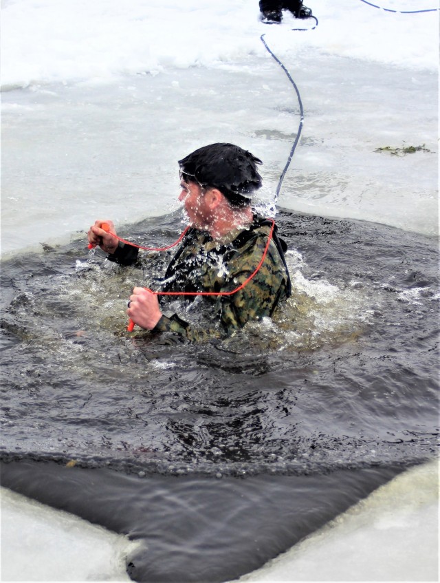 A Fort McCoy Cold-Weather Operations Course (CWOC) Class 21-02 student participates in cold-water immersion training Jan. 15, 2021, at Big Sandy Lake on South Post at Fort McCoy, Wis. CWOC students are trained on a variety of cold-weather...