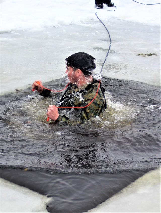 A Fort McCoy Cold-Weather Operations Course (CWOC) Class 21-02 student participates in cold-water immersion training Jan. 15, 2021, at Big Sandy Lake on South Post at Fort McCoy, Wis. CWOC students are trained on a variety of cold-weather subjects, including snowshoe training and skiing as well as how to use ahkio sleds and other gear. Training also focuses on terrain and weather analysis, risk management, cold-weather clothing, developing winter fighting positions in the field, camouflage and concealment, and numerous other areas that are important to know in order to survive and operate in a cold-weather environment. The training is coordinated through the Directorate of Plans, Training, Mobilization and Security at Fort McCoy. (U.S. Army Photo by Scott T. Sturkol, Public Affairs Office, Fort McCoy, Wis.)