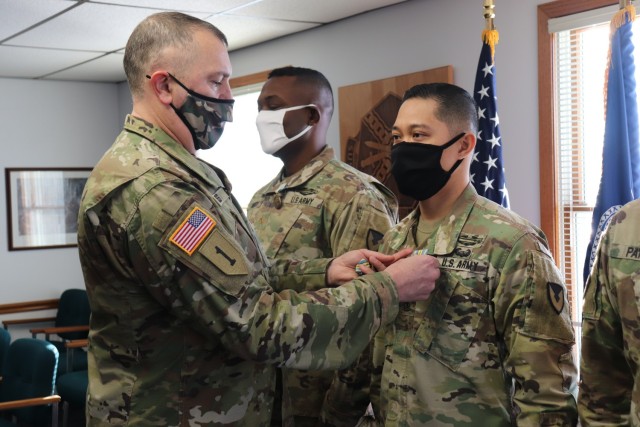 Garrison Commander Col. Michael D. Poss presents the Military Outstanding Volunteer Service Medal (MOVSM) to 1st Sgt. Leonardo Ramos of U.S. Army Garrison-Fort McCoy’s Headquarters and Headquarters Company on Jan. 22, 2021, in building 100 at...