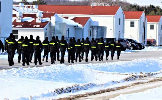 U.S. Navy recruits walk on the cantonment area Jan. 28, 2021, at Fort McCoy, Wis. The Navy’s Recruit Training Command (RTC) of Great Lakes, Ill., worked with the Army in 2020 at Fort McCoy so the post could serve as a restriction-of-movement (ROM) site for Navy recruits prior to entering basic training. Additional personnel support from the Navy’s Great Lakes, Ill., Millington, Tenn., and Washington, D.C., sites deployed to McCoy to assist RTC in conducting the initial 14-day ROM to help reduce the risk of bringing the coronavirus to RTC should any individual be infected. More than 40,000 recruits train annually at the Navy’s only boot camp. This is also the first time Fort McCoy has supported the Navy in this capacity. Fort McCoy’s motto is to be the “Total Force Training Center.” (U.S. Army Photo by Scott T. Sturkol, Public Affairs Office, Fort McCoy, Wis.)