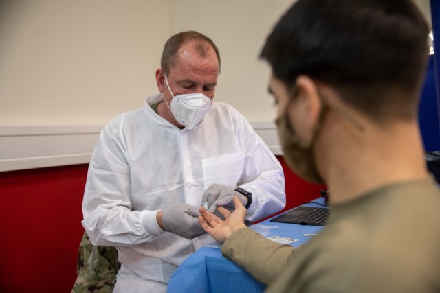 U.S. Army Staff Sgt. J Byers, assigned to 7390th Blood Detachment, checks a blood donor’s iron levels during the Armed Services Blood Program blood drive at the United Service Organizations center in Grafenwoehr, Germany, Feb. 2, 2021. The ASBP is the Department of Defense’s blood organization, serving military personnel around the world. (U.S. Army photo by Sgt. Joseph D. McDonald)