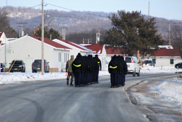 U.S. Navy recruits walk on the cantonment area Jan. 28, 2021, at Fort McCoy, Wis. The Navy’s Recruit Training Command (RTC) of Great Lakes, Ill., worked with the Army in 2020 at Fort McCoy so the post could serve as a restriction-of-movement (ROM) site for Navy recruits prior to entering basic training. Additional personnel support from the Navy’s Great Lakes, Ill., Millington, Tenn., and Washington, D.C., sites deployed to McCoy to assist RTC in conducting the initial 14-day ROM to help reduce the risk of bringing the coronavirus to RTC should any individual be infected. More than 40,000 recruits train annually at the Navy’s only boot camp. This is also the first time Fort McCoy has supported the Navy in this capacity. Fort McCoy’s motto is to be the “Total Force Training Center.” (U.S. Army Photo by Scott T. Sturkol, Public Affairs Office, Fort McCoy, Wis.)