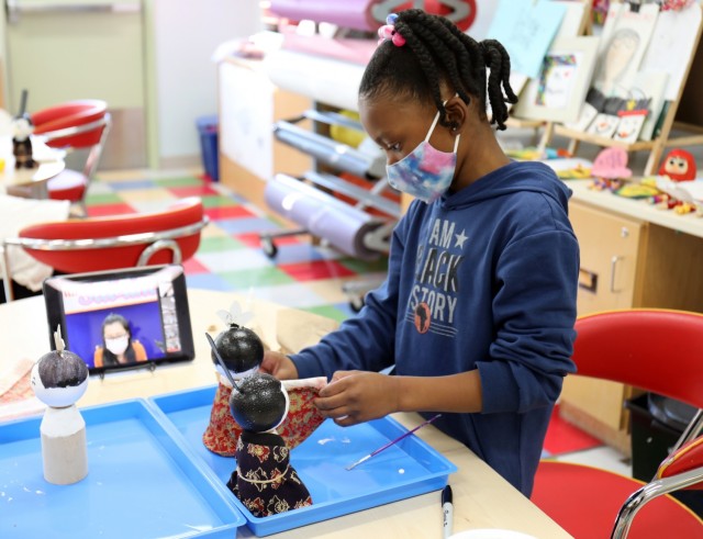 Amiyah Davis, 8, dresses a Japanese “Hinamatsuri” doll during a virtual craft class at the School Age Center, Sagamihara Family Housing Area, Japan, Feb. 9.