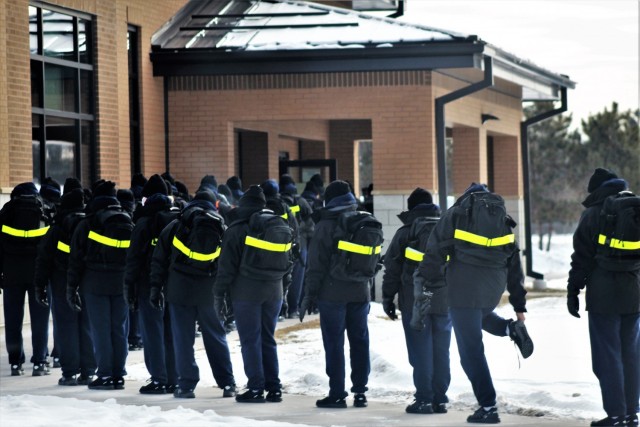 U.S. Navy recruits walk to a dining facility Jan. 28, 2021, at Fort McCoy, Wis. The Navy’s Recruit Training Command (RTC) of Great Lakes, Ill., worked with the Army in 2020 at Fort McCoy so the post could serve as a restriction-of-movement (ROM) site for Navy recruits prior to entering basic training. Additional personnel support from the Navy’s Great Lakes, Ill., Millington, Tenn., and Washington, D.C., sites deployed to McCoy to assist RTC in conducting the initial 14-day ROM to help reduce the risk of bringing the coronavirus to RTC should any individual be infected. More than 40,000 recruits train annually at the Navy’s only boot camp. This is also the first time Fort McCoy has supported the Navy in this capacity. Fort McCoy’s motto is to be the “Total Force Training Center.” (U.S. Army Photo by Scott T. Sturkol, Public Affairs Office, Fort McCoy, Wis.)