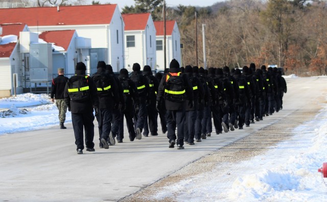 U.S. Navy recruits walk on the cantonment area Jan. 28, 2021, at Fort McCoy, Wis. The Navy’s Recruit Training Command (RTC) of Great Lakes, Ill., worked with the Army in 2020 at Fort McCoy so the post could serve as a restriction-of-movement (ROM) site for Navy recruits prior to entering basic training. Additional personnel support from the Navy’s Great Lakes, Ill., Millington, Tenn., and Washington, D.C., sites deployed to McCoy to assist RTC in conducting the initial 14-day ROM to help reduce the risk of bringing the coronavirus to RTC should any individual be infected. More than 40,000 recruits train annually at the Navy’s only boot camp. This is also the first time Fort McCoy has supported the Navy in this capacity. Fort McCoy’s motto is to be the “Total Force Training Center.” (U.S. Army Photo by Scott T. Sturkol, Public Affairs Office, Fort McCoy, Wis.)