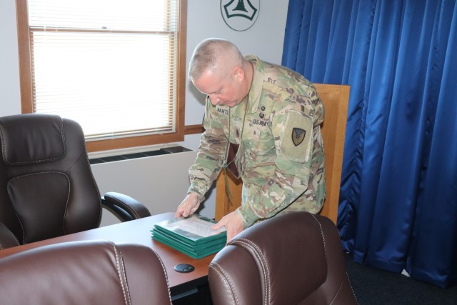 Command Sgt. Maj. Paul Mantha, garrison command sergeant major, reads an award citation as Garrison Commander Col. Michael D. Poss presents Maj. Eddie Woody, 1st Sgt. Leonardo Ramos, Sgt. 1st Class Gregory Parks, and Staff Sgt. Anthony Cintron...
