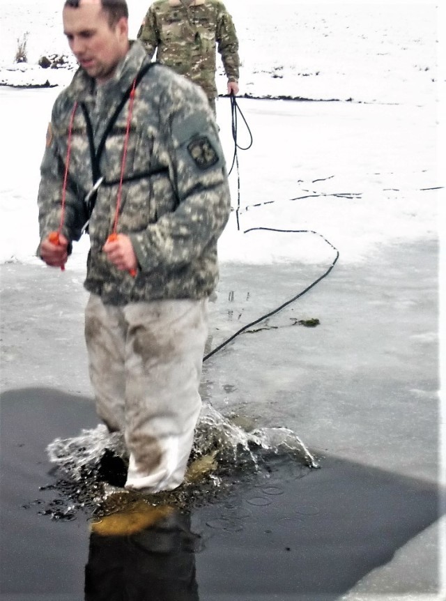 A Fort McCoy Cold-Weather Operations Course (CWOC) Class 21-02 student participates in cold-water immersion training Jan. 15, 2021, at Big Sandy Lake on South Post at Fort McCoy, Wis. CWOC students are trained on a variety of cold-weather subjects, including snowshoe training and skiing as well as how to use ahkio sleds and other gear. Training also focuses on terrain and weather analysis, risk management, cold-weather clothing, developing winter fighting positions in the field, camouflage and concealment, and numerous other areas that are important to know in order to survive and operate in a cold-weather environment. The training is coordinated through the Directorate of Plans, Training, Mobilization and Security at Fort McCoy. (U.S. Army Photo by Scott T. Sturkol, Public Affairs Office, Fort McCoy, Wis.)