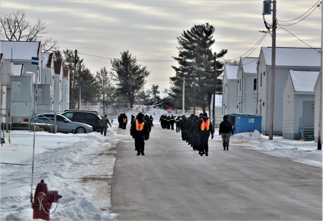 U.S. Navy recruits walk on the cantonment area Jan. 28, 2021, at Fort McCoy, Wis. The Navy’s Recruit Training Command (RTC) of Great Lakes, Ill., worked with the Army at Fort McCoy so the post could serve as a restriction-of-movement (ROM) site for Navy recruits prior to entering basic training. Additional personnel support from the Navy’s Great Lakes, Ill., Millington, Tenn., and Washington, D.C., sites deployed to McCoy to assist RTC in conducting the initial 14-day ROM to help reduce the risk of bringing the coronavirus to RTC should any individual be infected. More than 40,000 recruits train annually at the Navy’s only boot camp. This is also the first time Fort McCoy has supported the Navy in this capacity. Fort McCoy’s motto is to be the “Total Force Training Center.” (U.S. Army Photo by Scott T. Sturkol, Public Affairs Office, Fort McCoy, Wis.)