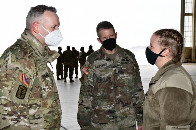 Spc. Angela Thresher (center), a 68W Combat Medic from Washington State who was identified as the 10,000th Soldier to depart from MEDCoE in a controlled manner as part of the COVID-19 pandemic, speaks with Maj. Gen. Dennis LeMaster, MEDCoE Commanding General and Command Sgt. Maj. Clark Charpentier, MEDCoE Command Sergeant Major.

U.S. Army Medical Center of Excellence on February 11, 2021 as they conducted a controlled outbound movement from Joint Base San Antonio (JBSA)- Kelly Field for over 250 Soldiers departing Advanced Individual Training (AIT) in various medical military occupational specialties at JBSA on February 11, 2021.

With this move, the medical education and training institution commemorated the 10,000th AIT Soldier moved in this controlled manner as part of their COVID-19 mitigation measures. All outbound Soldiers who depart the relative safety bubble of the training environment are confirmed COVID-negative. The first controlled movement was nine months ago on April 7, 2020.

