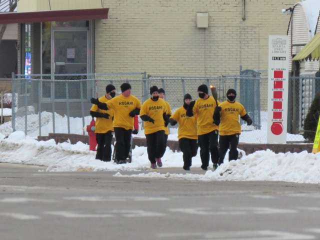 Members of the Fort McCoy, Wis., Army Ten-Miler team carry an event torch Jan. 29, 2021, as part of the opening ceremony of the Sparta Quest Winter Fest in Sparta, Wis. On Jan. 29, members of the team, along with Command Sgt. Maj. Paul Mantha,...