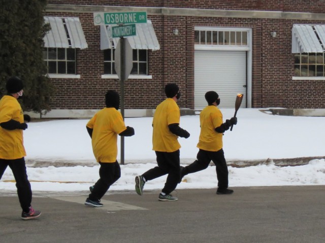 Members of the Fort McCoy, Wis., Army Ten-Miler team carry an event torch Jan. 29, 2021, as part of the opening ceremony of the Sparta Quest Winter Fest in Sparta, Wis. On Jan. 29, members of the team, along with Command Sgt. Maj. Paul Mantha,...