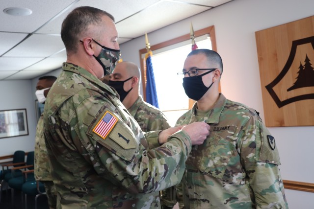 Garrison Commander Col. Michael D. Poss presents the Military Outstanding Volunteer Service Medal (MOVSM) to Staff Sgt. Anthony Cintron of U.S. Army Garrison-Fort McCoy’s Headquarters and Headquarters Company on Jan. 22, 2021, in building 100 at...