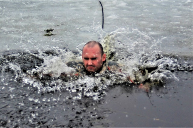 A Fort McCoy Cold-Weather Operations Course (CWOC) Class 21-02 student participates in cold-water immersion training Jan. 15, 2021, at Big Sandy Lake on South Post at Fort McCoy, Wis. CWOC students are trained on a variety of cold-weather subjects, including snowshoe training and skiing as well as how to use ahkio sleds and other gear. Training also focuses on terrain and weather analysis, risk management, cold-weather clothing, developing winter fighting positions in the field, camouflage and concealment, and numerous other areas that are important to know in order to survive and operate in a cold-weather environment. The training is coordinated through the Directorate of Plans, Training, Mobilization and Security at Fort McCoy. (U.S. Army Photo by Scott T. Sturkol, Public Affairs Office, Fort McCoy, Wis.)