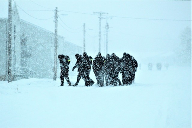U.S. Navy recruits walk on the cantonment area in a snowstorm Feb. 4, 2021, at Fort McCoy, Wis. The Navy’s Recruit Training Command (RTC) of Great Lakes, Ill., worked with the Army in 2020 at Fort McCoy so the post could serve as a restriction-of-movement (ROM) site for Navy recruits prior to entering basic training. Additional personnel support from the Navy’s Great Lakes, Ill., Millington, Tenn., and Washington, D.C., sites deployed to McCoy to assist RTC in conducting the initial 14-day ROM to help reduce the risk of bringing the coronavirus to RTC should any individual be infected. More than 40,000 recruits train annually at the Navy’s only boot camp. This is also the first time Fort McCoy has supported the Navy in this capacity. Fort McCoy’s motto is to be the “Total Force Training Center.” (U.S. Army Photo by Scott T. Sturkol, Public Affairs Office, Fort McCoy, Wis.)