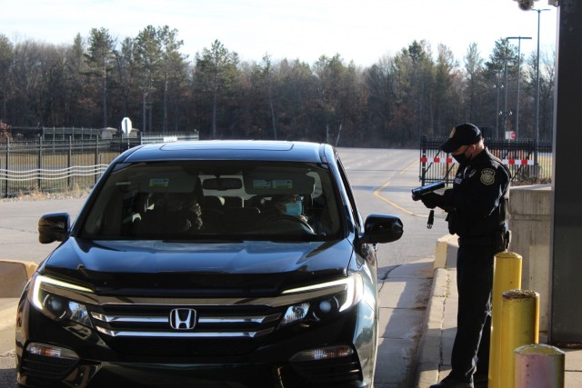 A police officer with the Directorate of Emergency Services Police Department scans an identification card while practicing COVID-19 safety protocols Dec. 3, 2020, at Fort McCoy, Wis. Throughout the installation's pandemic response, which started...