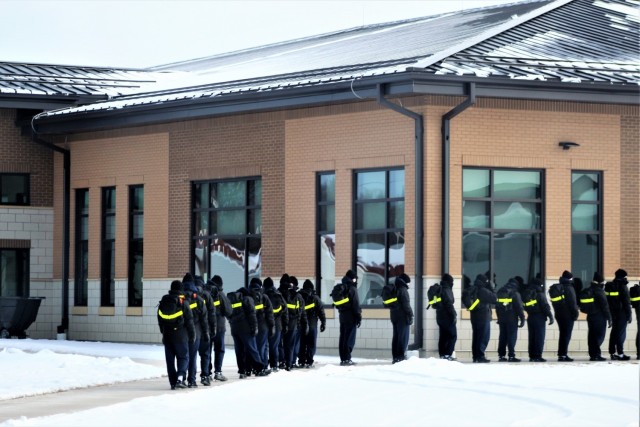 U.S. Navy recruits walk to a dining facility Jan. 28, 2021, at Fort McCoy, Wis. The Navy’s Recruit Training Command (RTC) of Great Lakes, Ill., worked with the Army in 2020 at Fort McCoy so the post could serve as a restriction-of-movement (ROM) site for Navy recruits prior to entering basic training. Additional personnel support from the Navy’s Great Lakes, Ill., Millington, Tenn., and Washington, D.C., sites deployed to McCoy to assist RTC in conducting the initial 14-day ROM to help reduce the risk of bringing the coronavirus to RTC should any individual be infected. More than 40,000 recruits train annually at the Navy’s only boot camp. This is also the first time Fort McCoy has supported the Navy in this capacity. Fort McCoy’s motto is to be the “Total Force Training Center.” (U.S. Army Photo by Scott T. Sturkol, Public Affairs Office, Fort McCoy, Wis.)