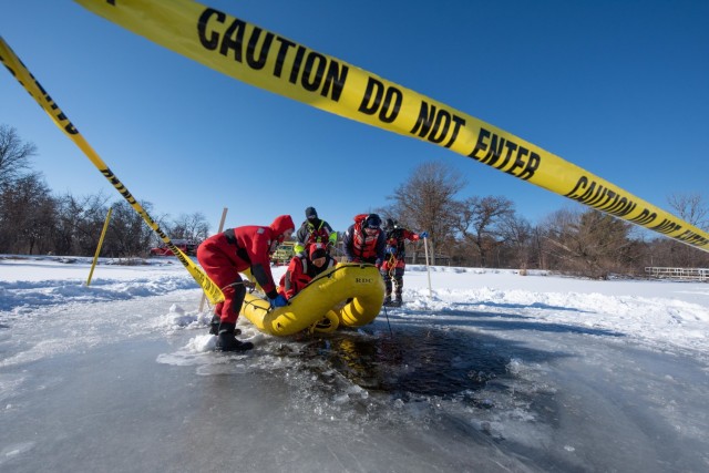 Firefighters with the Directorate of Emergency Services Fire Department dive team prepares surface rescue training on ice Feb. 3, 2021, at Big Sandy Lake on South Post at Fort McCoy, Wis. The department conducts surface and dive training with ice-covered lakes on post annually. (U.S. Army Photo by Cedar Wolf, Fort McCoy Multimedia-Visual Information Office)