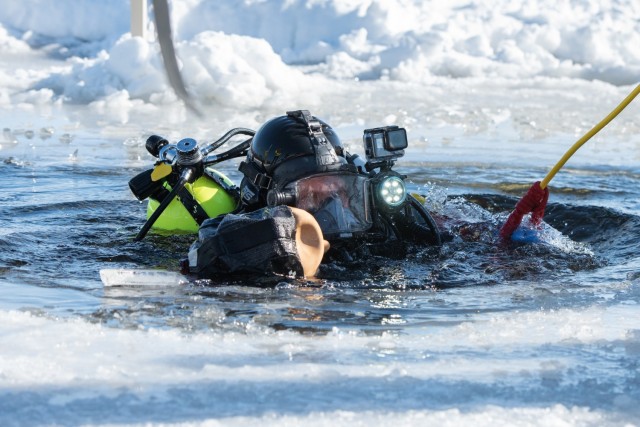 A firefighter with the Directorate of Emergency Services Fire Department dive team completes dive training under ice Feb. 3, 2021, at Big Sandy Lake on South Post at Fort McCoy, Wis. The department conducts surface and dive training with...