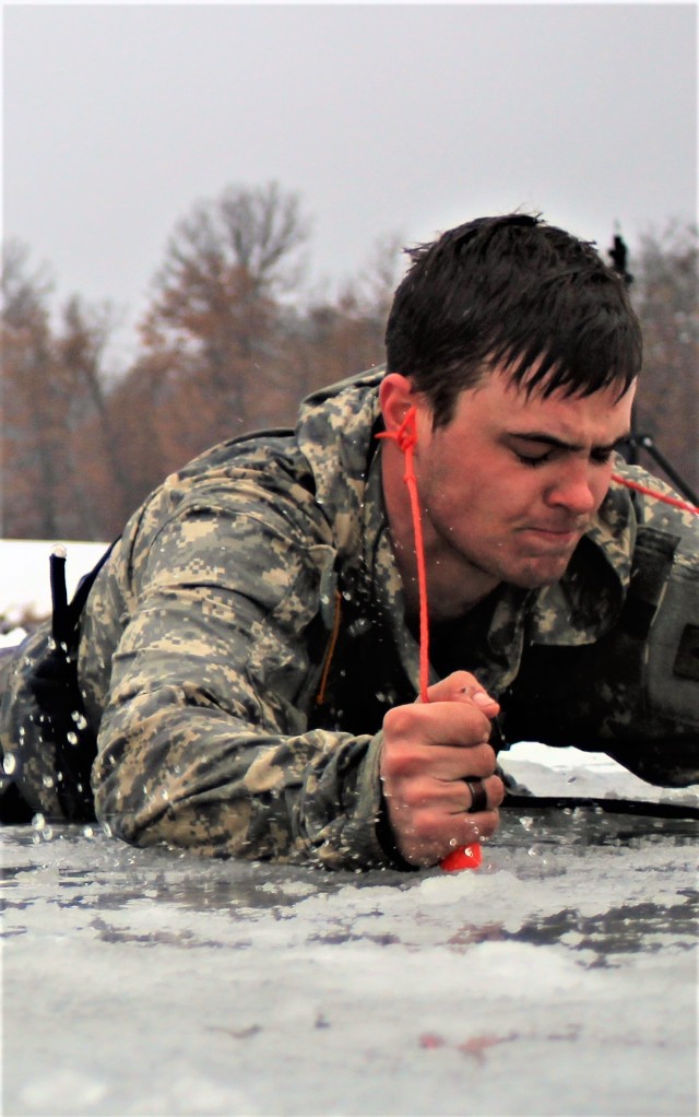 A Fort McCoy Cold-Weather Operations Course (CWOC) Class 21-02 student participates in cold-water immersion training Jan. 15, 2021, at Big Sandy Lake on South Post at Fort McCoy, Wis. CWOC students are trained on a variety of cold-weather subjects, including snowshoe training and skiing as well as how to use ahkio sleds and other gear. Training also focuses on terrain and weather analysis, risk management, cold-weather clothing, developing winter fighting positions in the field, camouflage and concealment, and numerous other areas that are important to know in order to survive and operate in a cold-weather environment. The training is coordinated through the Directorate of Plans, Training, Mobilization and Security at Fort McCoy. (U.S. Army Photo by Scott T. Sturkol, Public Affairs Office, Fort McCoy, Wis.)