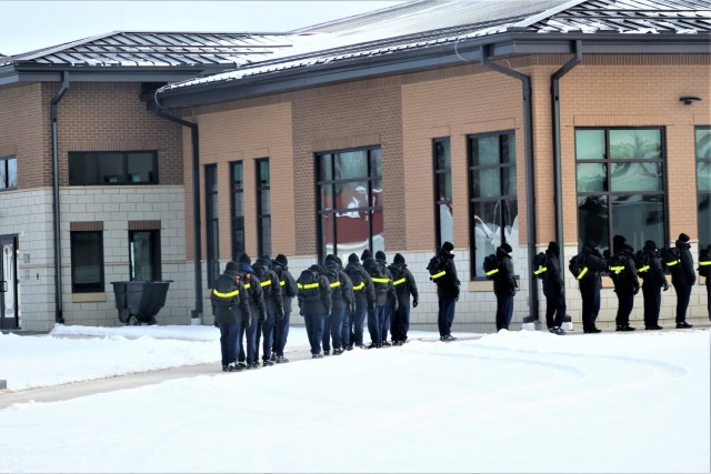 U.S. Navy recruits walk to a dining facility Jan. 28, 2021, at Fort McCoy, Wis. The Navy’s Recruit Training Command (RTC) of Great Lakes, Ill., worked with the Army in 2020 at Fort McCoy so the post could serve as a restriction-of-movement (ROM) site for Navy recruits prior to entering basic training. Additional personnel support from the Navy’s Great Lakes, Ill., Millington, Tenn., and Washington, D.C., sites deployed to McCoy to assist RTC in conducting the initial 14-day ROM to help reduce the risk of bringing the coronavirus to RTC should any individual be infected. More than 40,000 recruits train annually at the Navy’s only boot camp. This is also the first time Fort McCoy has supported the Navy in this capacity. Fort McCoy’s motto is to be the “Total Force Training Center.” (U.S. Army Photo by Scott T. Sturkol, Public Affairs Office, Fort McCoy, Wis.)