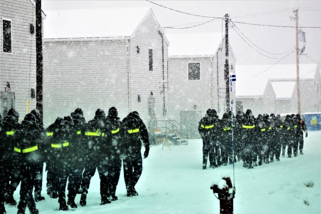 U.S. Navy recruits walk on the cantonment area in a snowstorm Feb. 4, 2021, at Fort McCoy, Wis. The Navy’s Recruit Training Command (RTC) of Great Lakes, Ill., worked with the Army in 2020 at Fort McCoy so the post could serve as a...