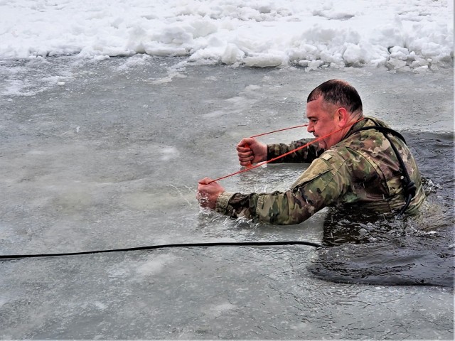 Fort McCoy Garrison Commander Col. Michael D. Poss participates in a cold-water immersion familiarization event Jan. 15, 2021, at Fort McCoy, Wis. Poss was learning about this training event that is part of the Fort McCoy Cold-Weather Operations...